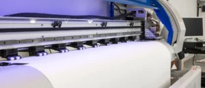 Wide-format printer printing a large white sheet