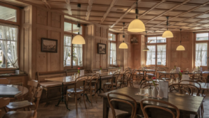 Wood-panelled restaurant dining room with set tables and pendant lights