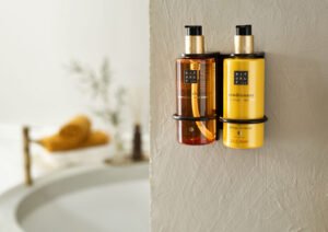 Rituals pump bottles in a wall holder above a bathtub
