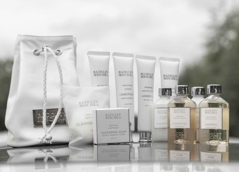 Badgley Mischka amenity set with tubes, bottles, cleansing soap and drawstring pouch