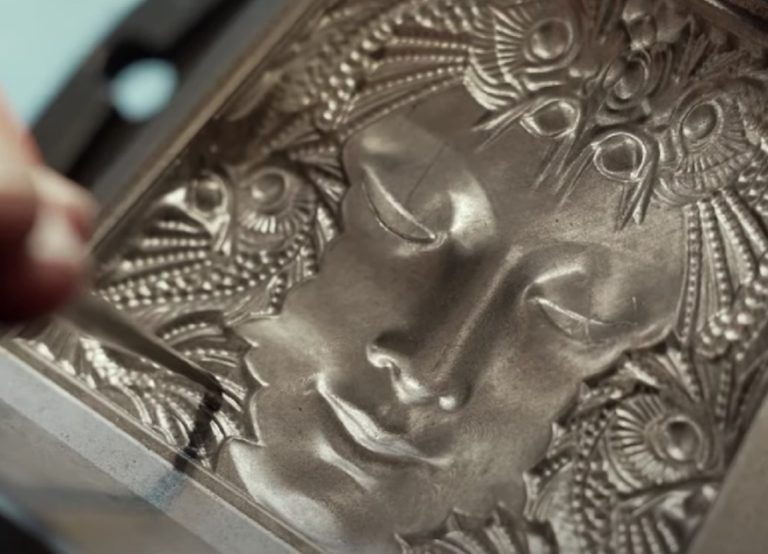 Close-up of a Lalique relief panel showing a woman's face