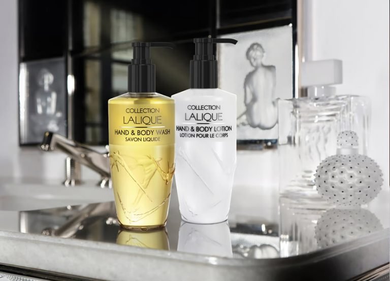 Collection Lalique hand and body wash and body lotion beside a crystal bottle