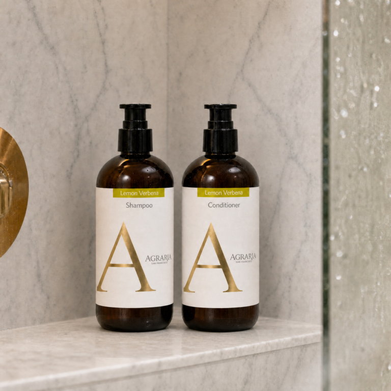 Agraria 360 ml shampoo and conditioner pump bottles on a shower shelf