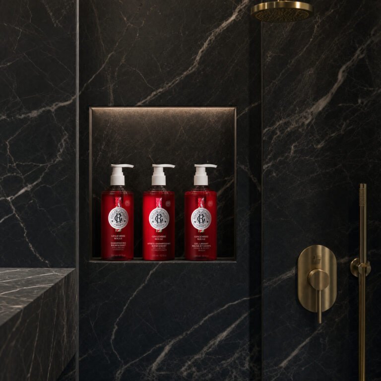 Roger & Gallet pump bottles in a marble shower niche