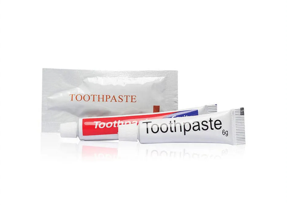 Packs of toothpaste and toothbrush