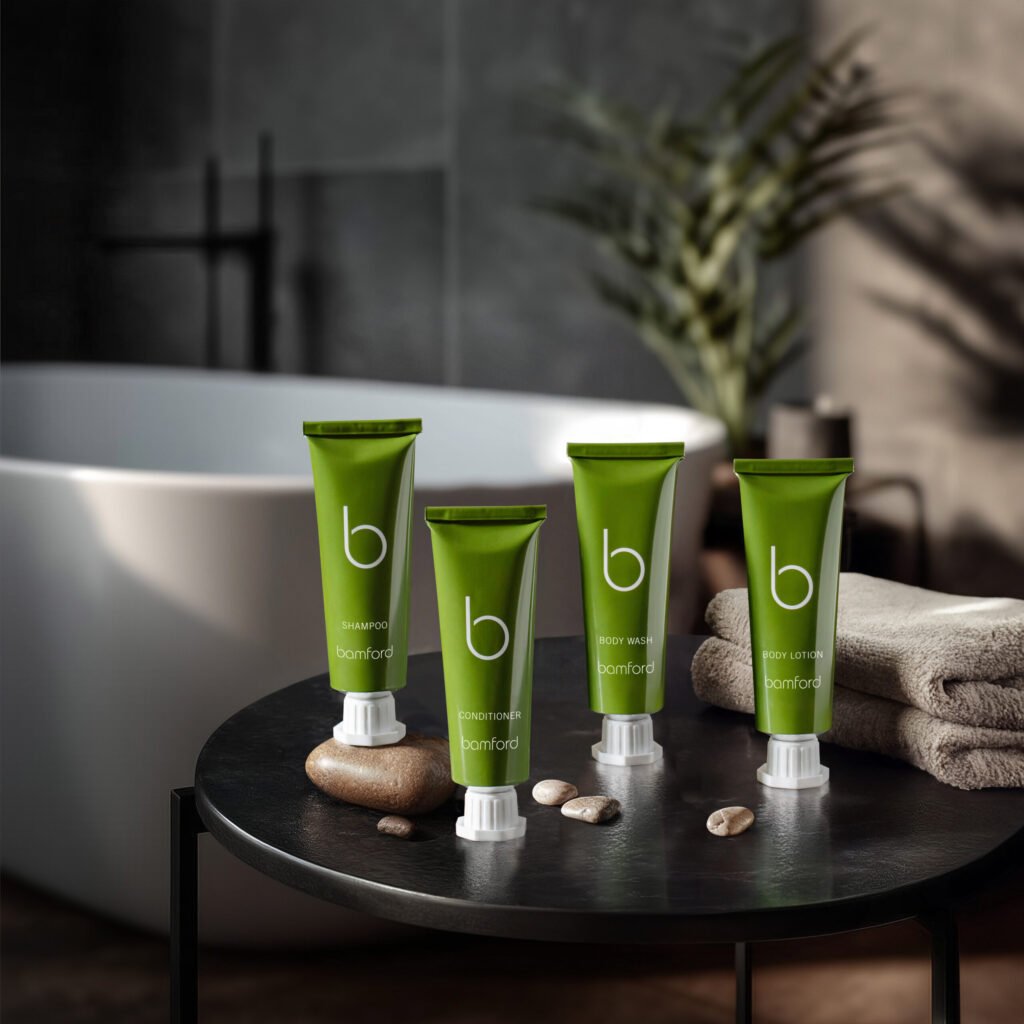 Bamford amenity tubes on a stool beside a bathtub