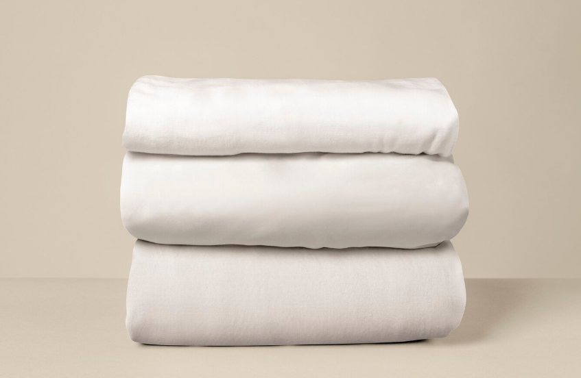 Stack of folded white bed sheets