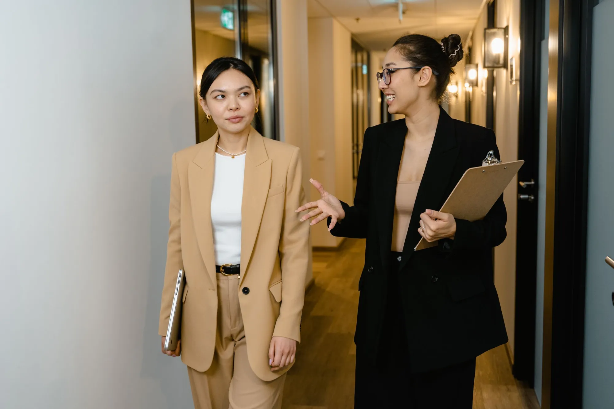 Two smiling businesswomen discussing a deal