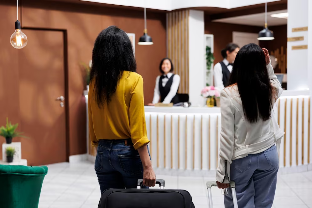 Guests with luggage arriving at a hotel reception