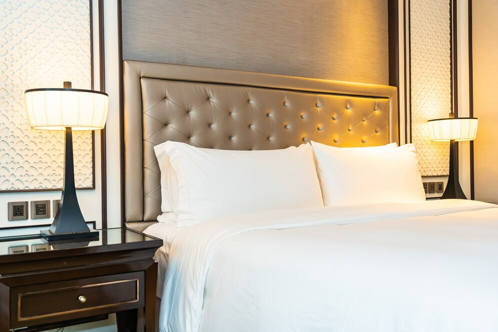 Hotel room with a made bed and bedside lamps