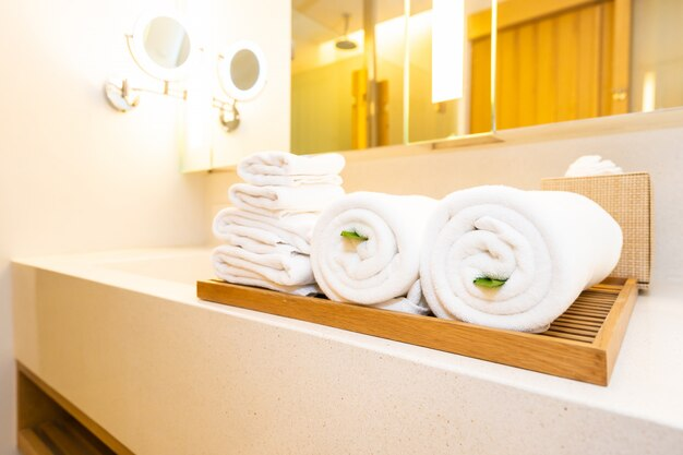 Rolled white towels on a bathroom counter
