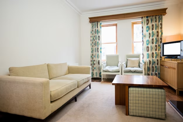 Hotel suite living room with a sofa and armchairs