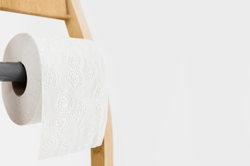 Toilet paper roll on a wooden holder