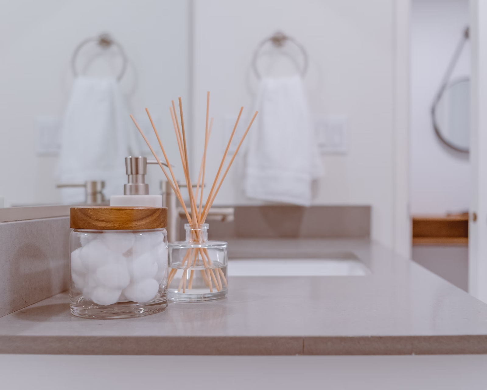 Bathroom counter with cotton pads and a reed diffuser