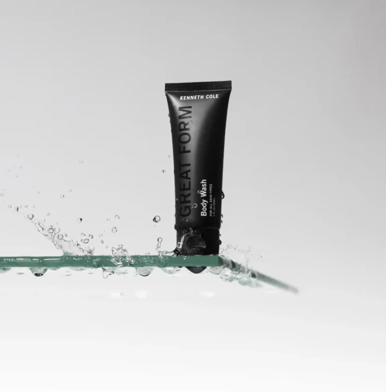 Kenneth Cole Great Form body wash tube on a wet glass shelf