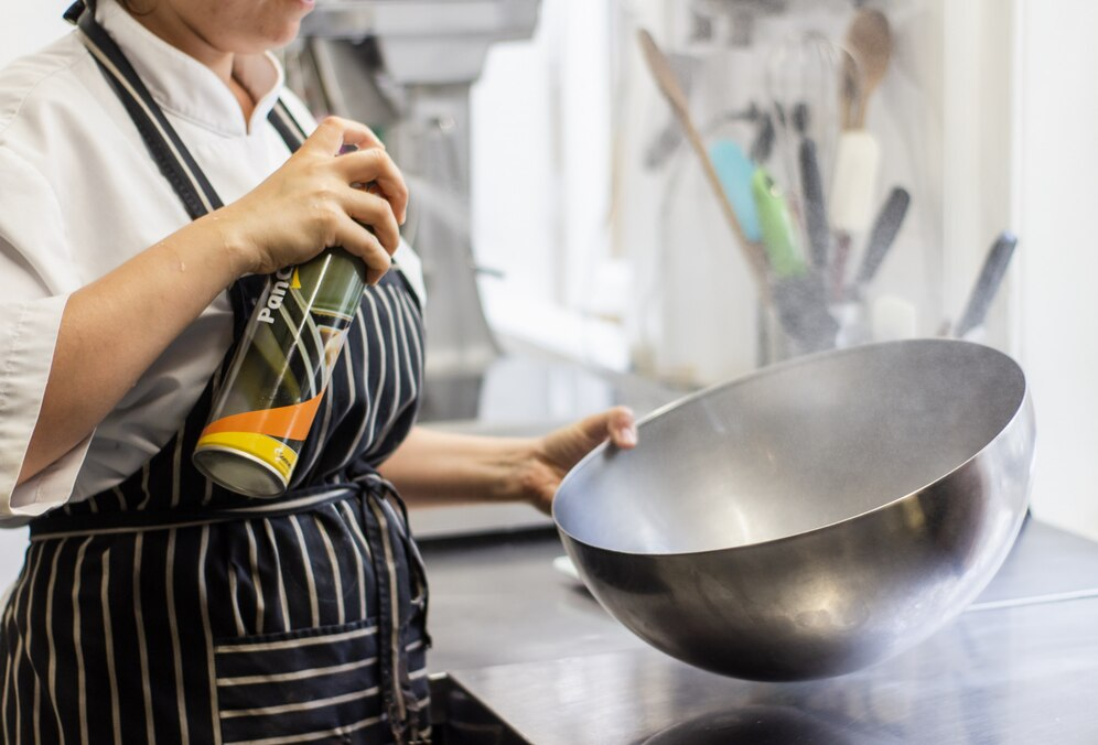 Chef cooking with a steel wok in a restaurant kitchen